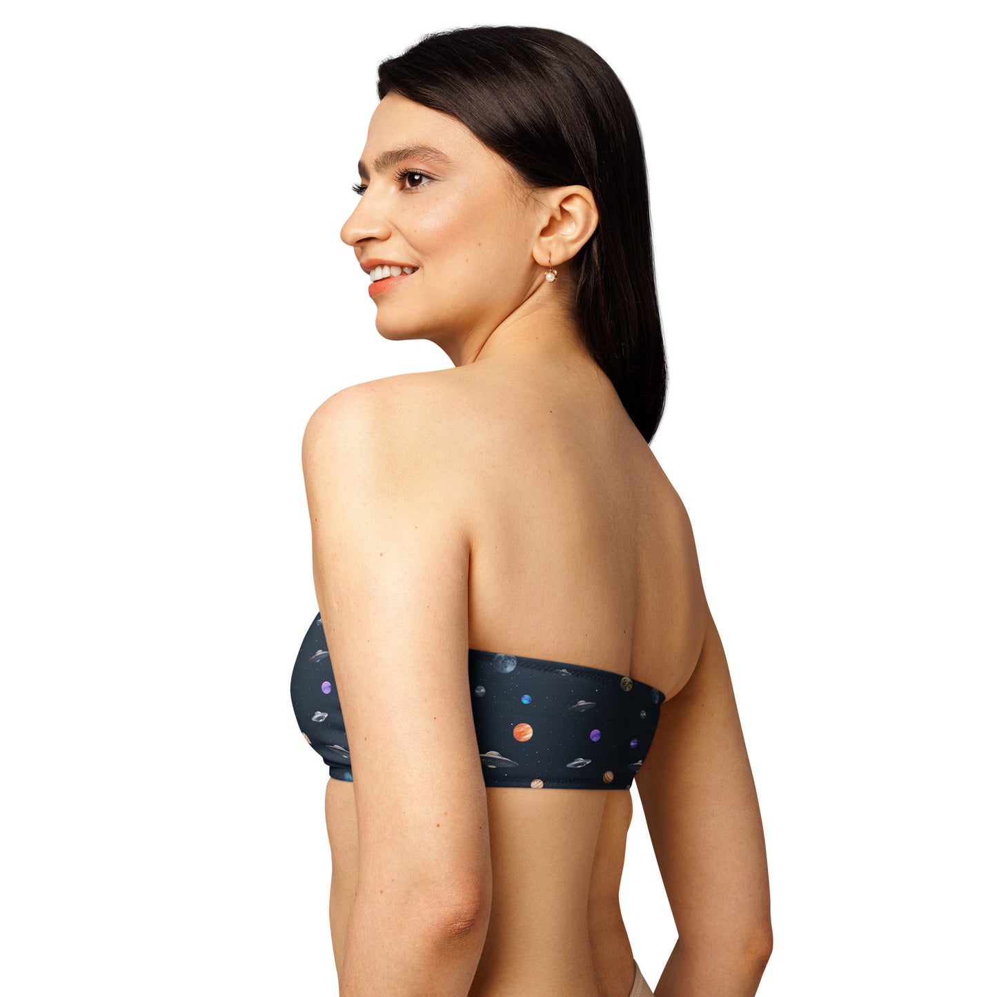 Woman wearing bikini top with pattern of UFOs and planets in space.