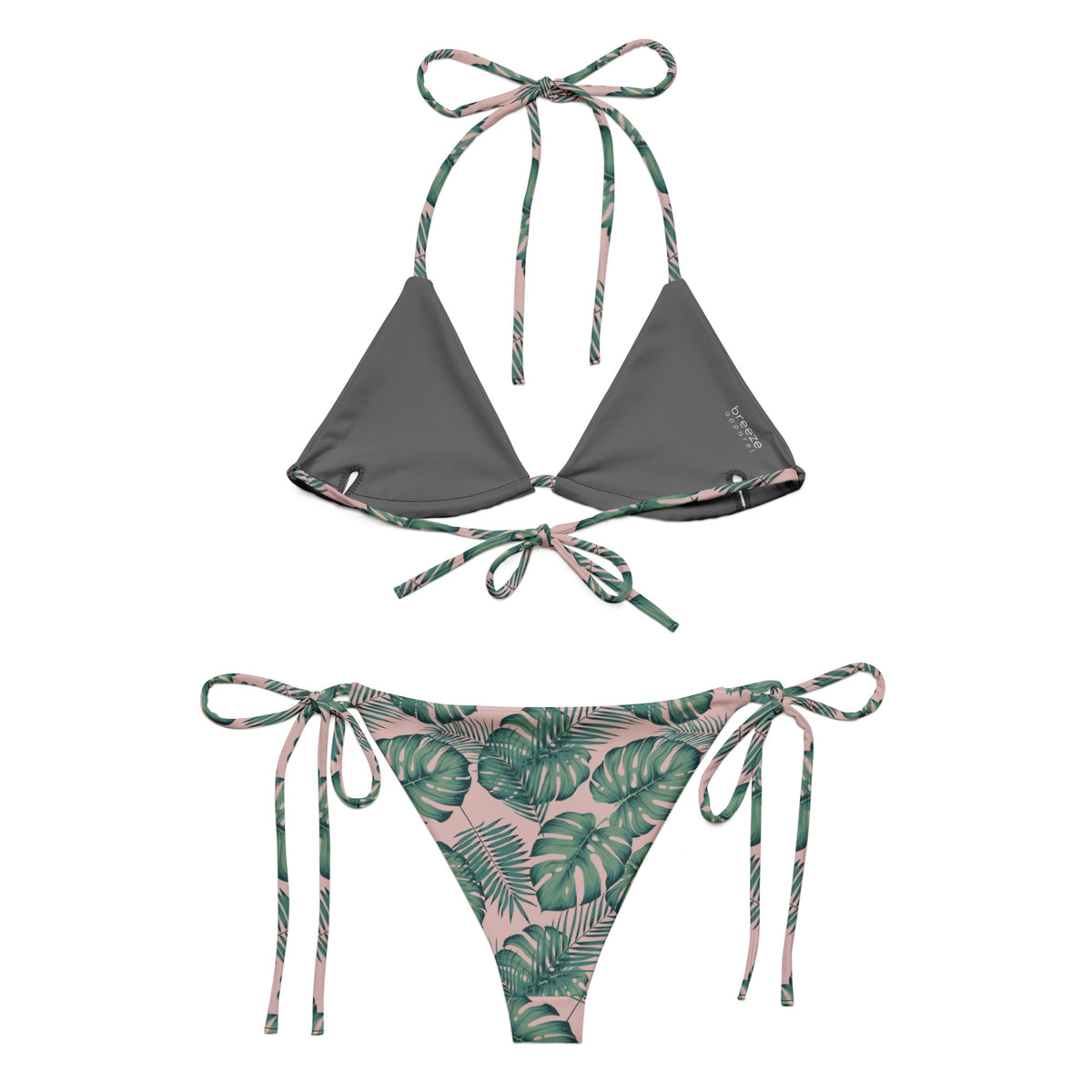 Back of bikini with pattern of green palm leaves set on a pink background. Interior is dark gray.