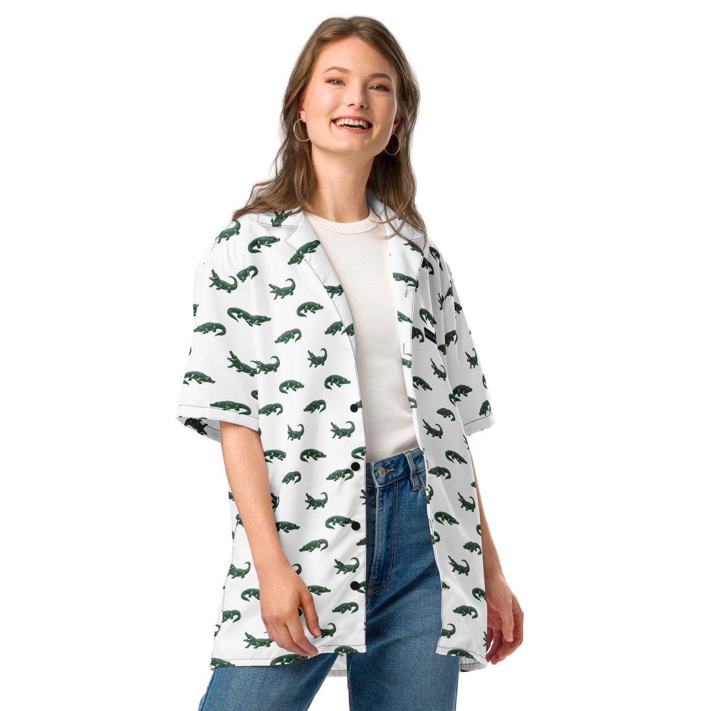 Woman wearing white button-down shirt with pattern of green alligators.