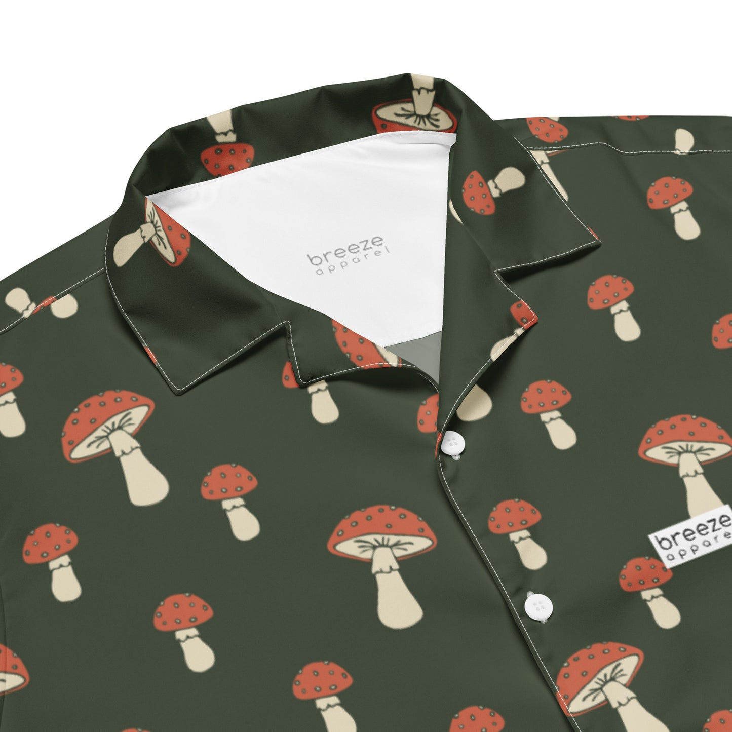 Button-down shirt with pattern of mushrooms set on a green background.