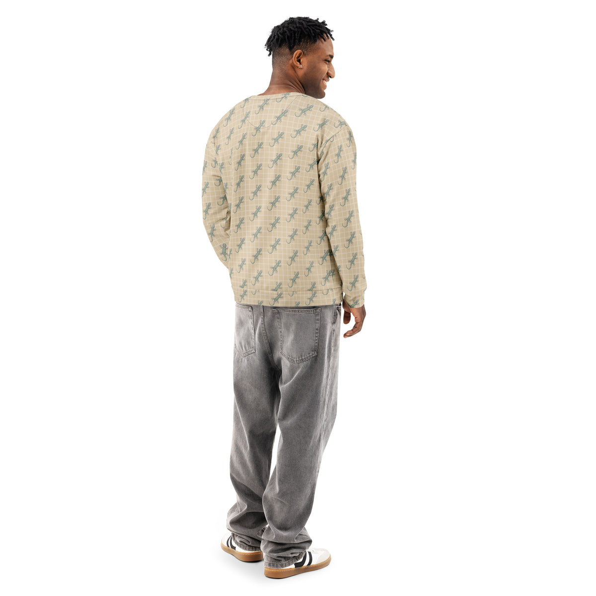 Rear view of man wearing beige sweatshirt with pattern of green geckos.