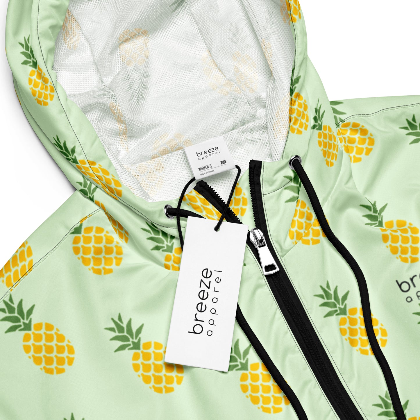Jacket with pattern of pineapples set on a light-green background.