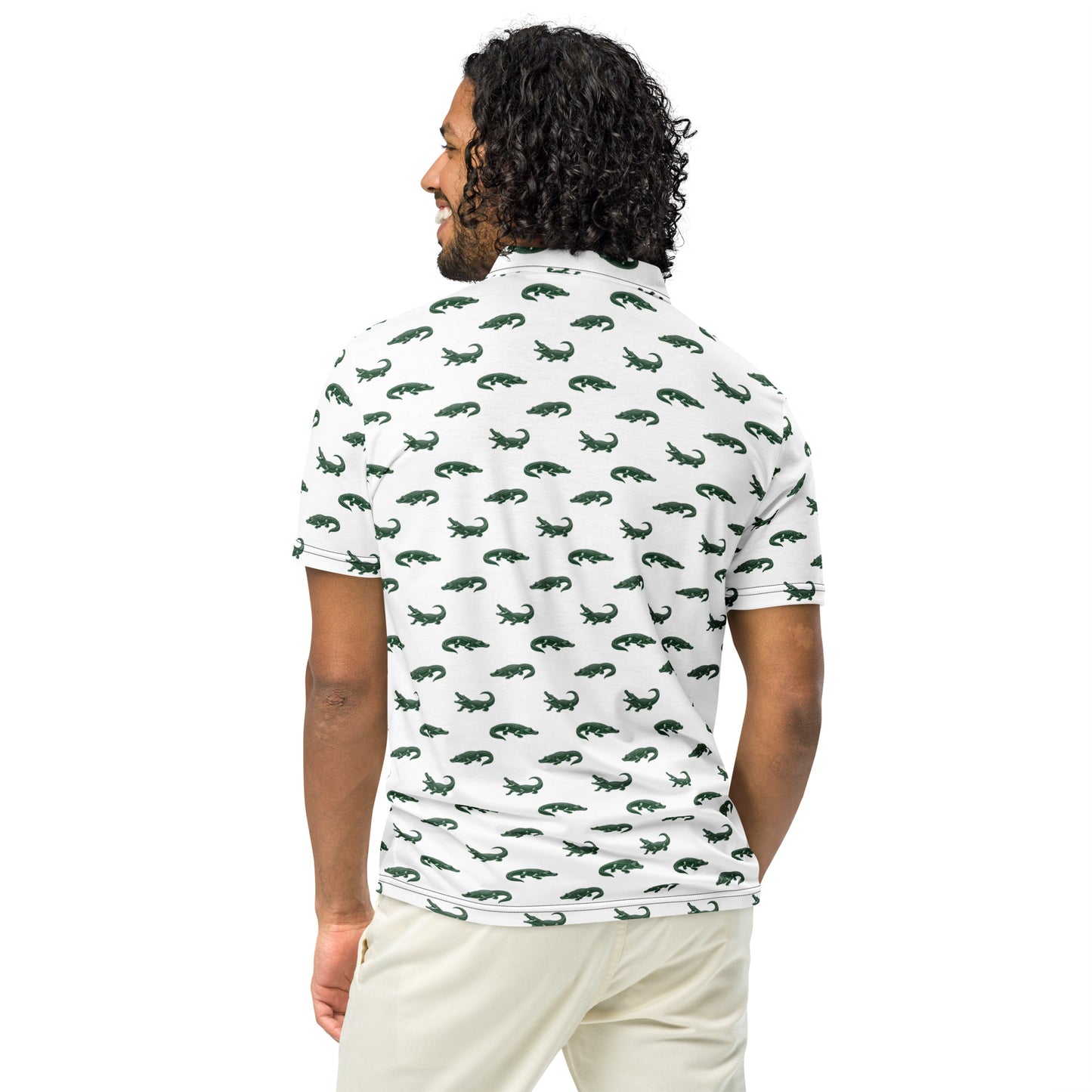 Man wearing white polo with pattern of green alligators.