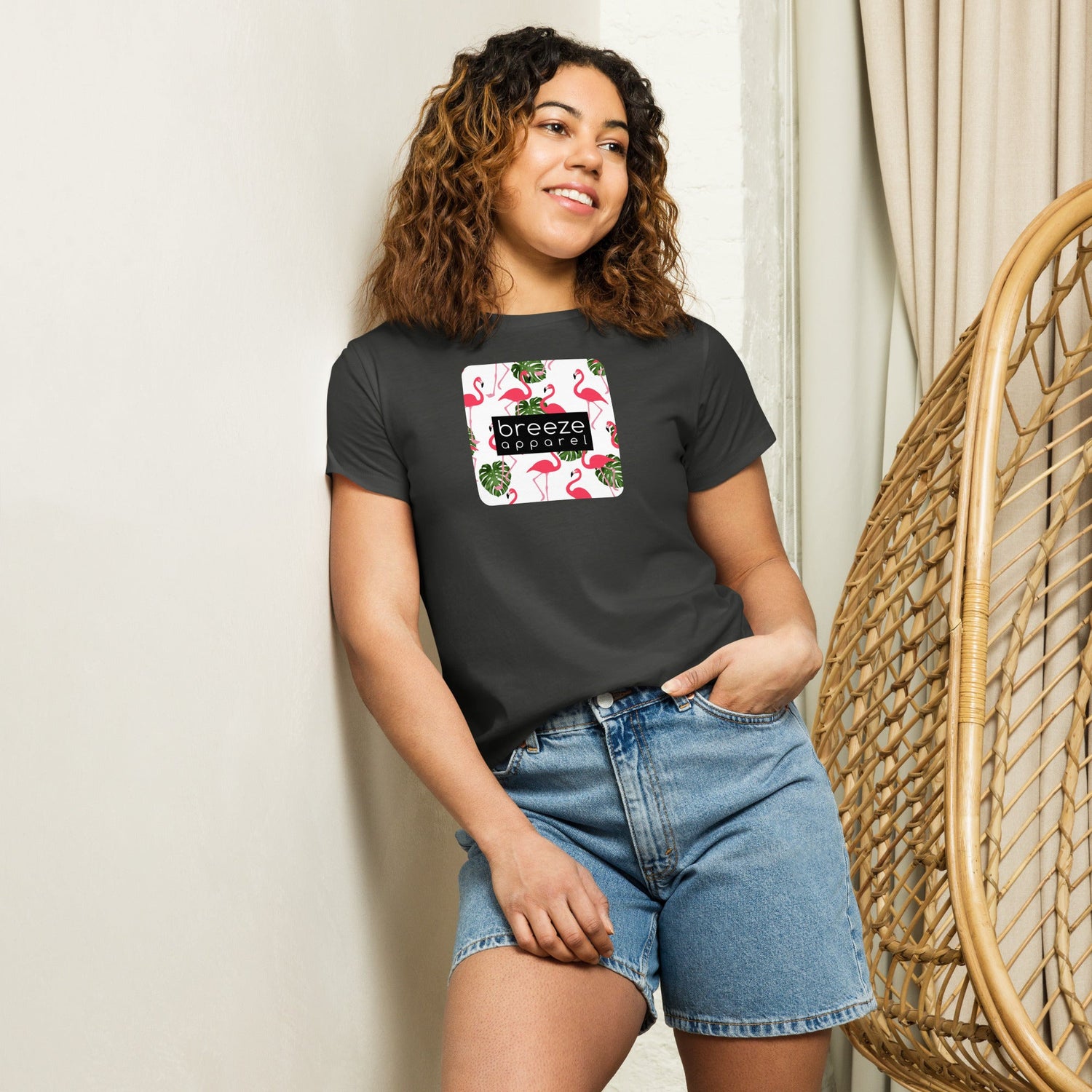 Woman wearing black t-shirt with flamingos graphic.