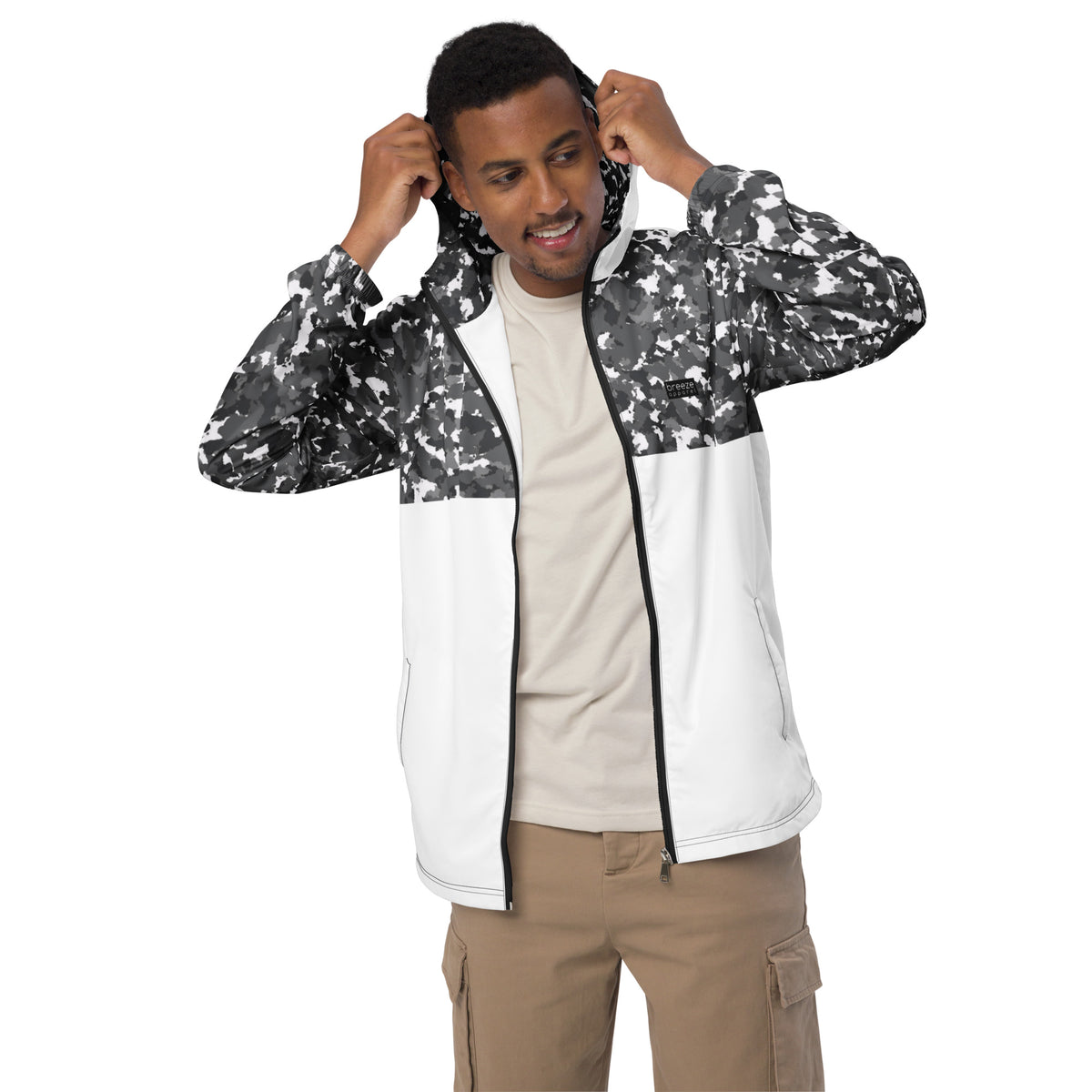 Man wearing jacket with black-gray-white camouflage pattern on hood interior, top, and sleeves; rest is white.
