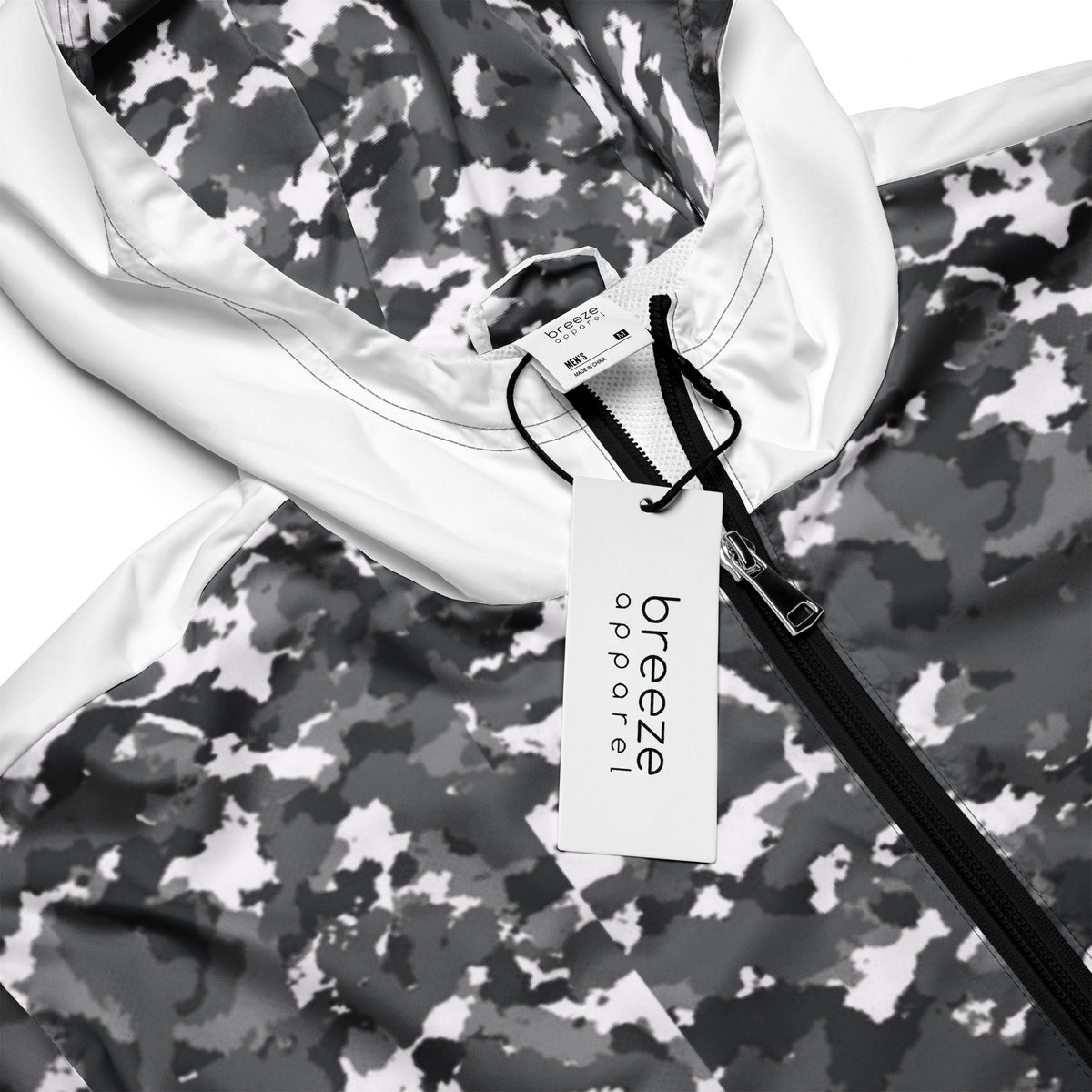 Close-up of jacket that has a black-gray-white camouflage pattern on hood interior and top; rest is white.