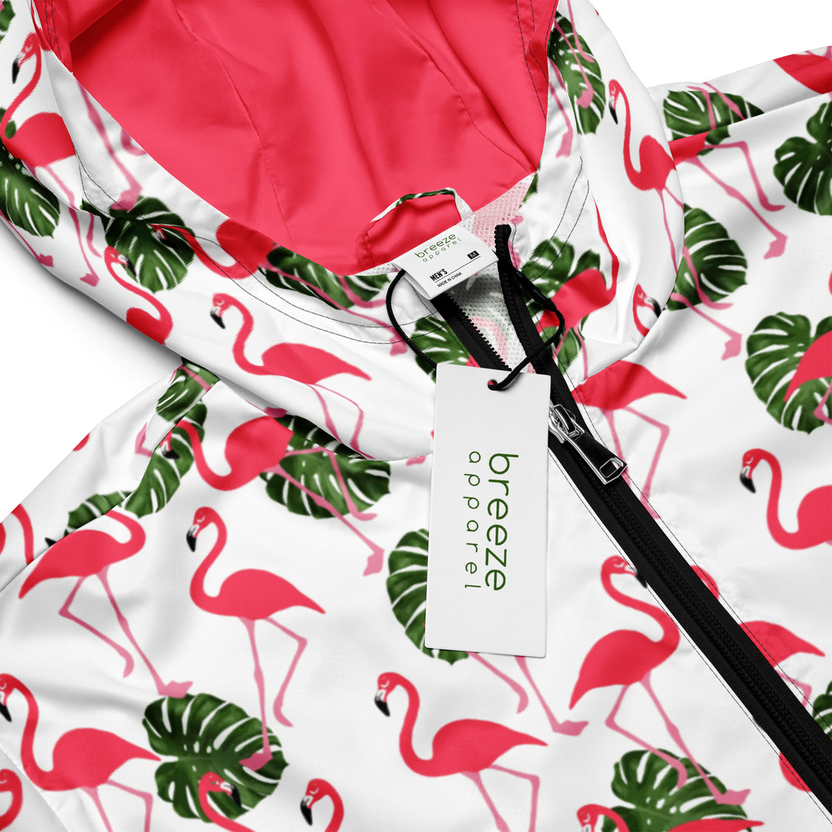 Jacket with pattern of pink flamingos and green foliage set on a white background.
