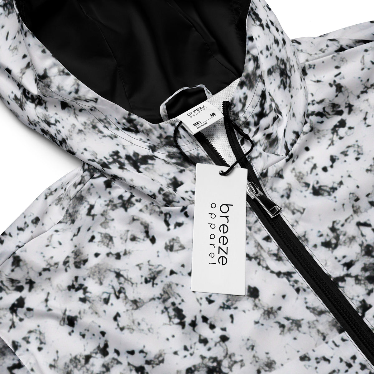 Jacket with pattern of black splotches on a white background.