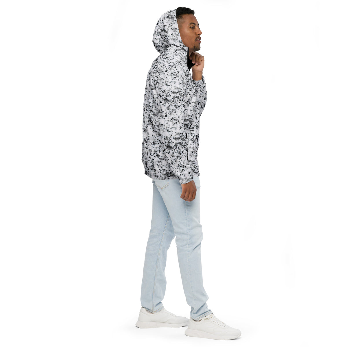 Man wearing jacket with pattern of black splotches on a white background.