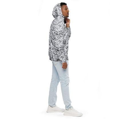 Man wearing jacket with pattern of black splotches on a white background.