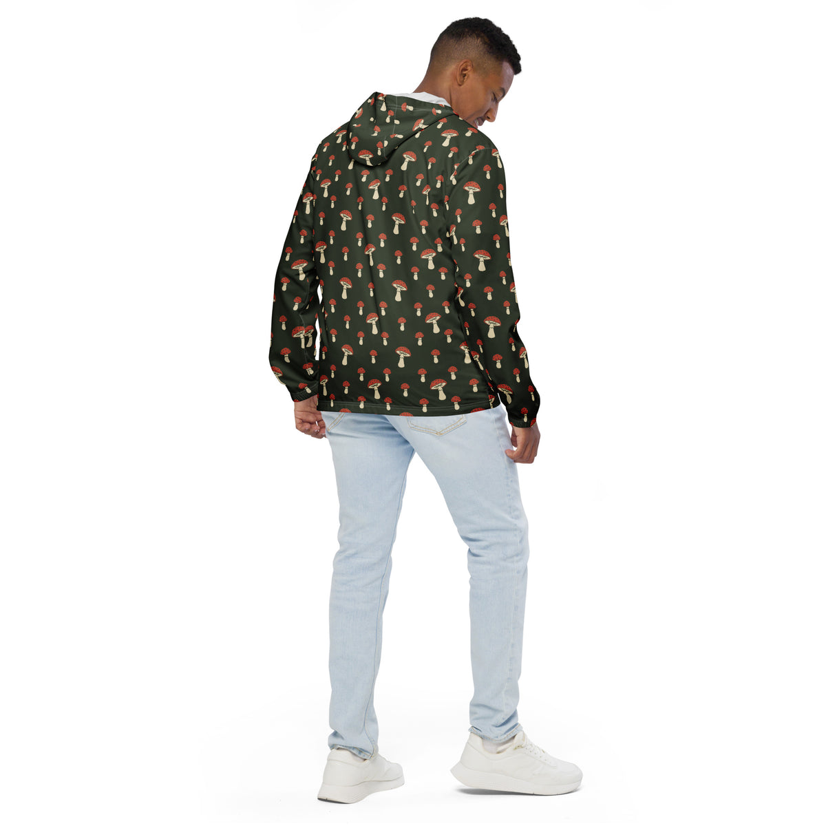 Rear view of man wearing jacket with pattern of mushrooms set on a green background.