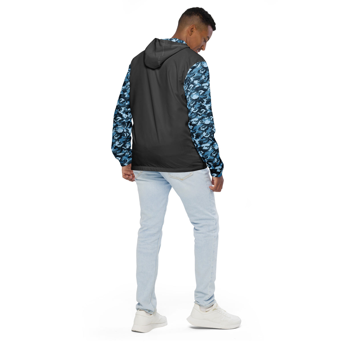 Rear view of man wearing jacket that has a gray back and a navy camouflage pattern on the sleeves.