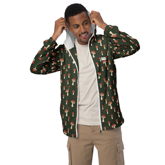 Man wearing jacket with pattern of mushrooms set on a green background.