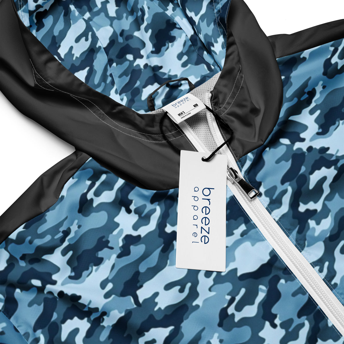 Close-up of jacket that has navy camouflage pattern on hood interior and on front; rest is gray.