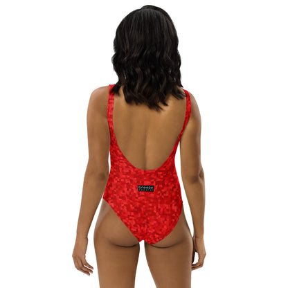 Rear view of woman wearing one-piece swimsuit with an all-over, red geometric pattern.