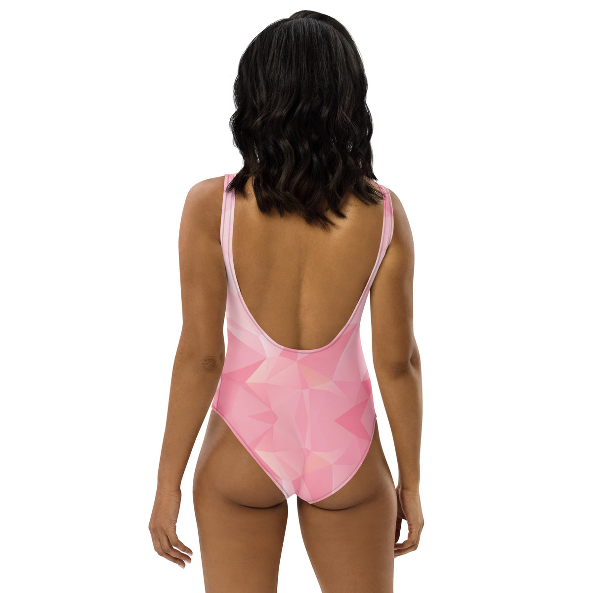 Rear view of woman wearing one-piece swimsuit with all-over, pink geometric pattern.
