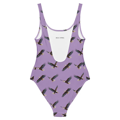 Purple one-piece swimsuit with pattern of bald eagles.