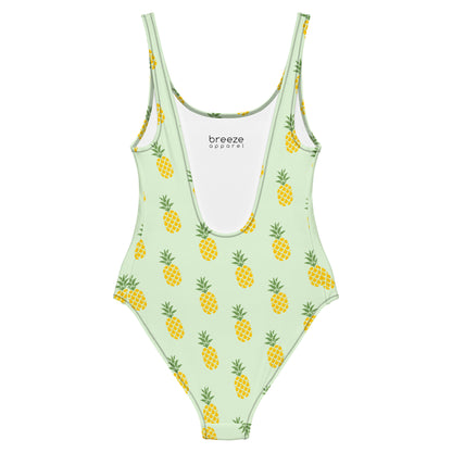 Light-green, one-piece swimsuit with pattern of pineapples.
