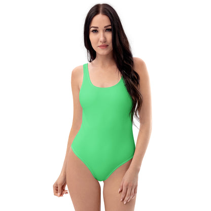 Woman wearing a mint-green one-piece swimsuit