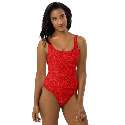 Woman wearing one-piece swimsuit with an all-over, red geometric pattern.