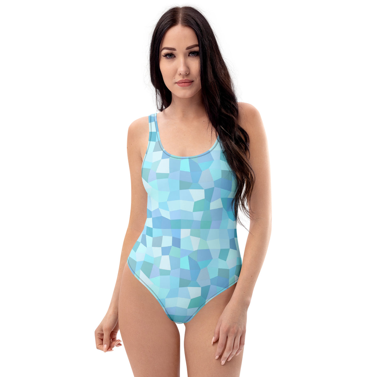 Woman wearing one-piece swimsuit with all-over, cyan geometric pattern.