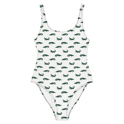 White one-piece swimsuit with pattern of green alligators.