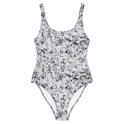 One-piece swimsuit with pattern of black splotches set on a white background.