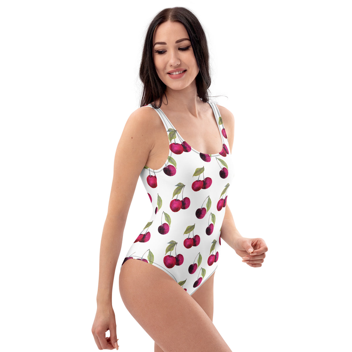 Woman wearing white, one-piece swimsuit with pattern of cherries.