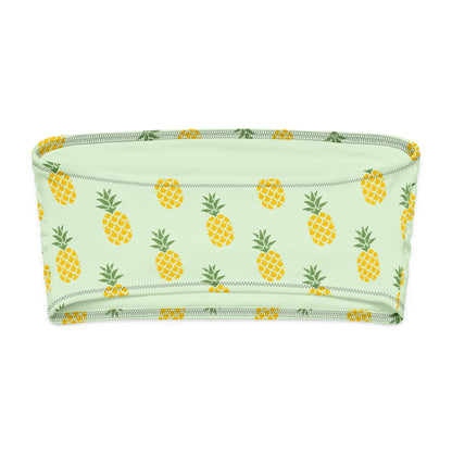 Back of bandeau bikini top with all-over pineapple design, set on a light-green background.