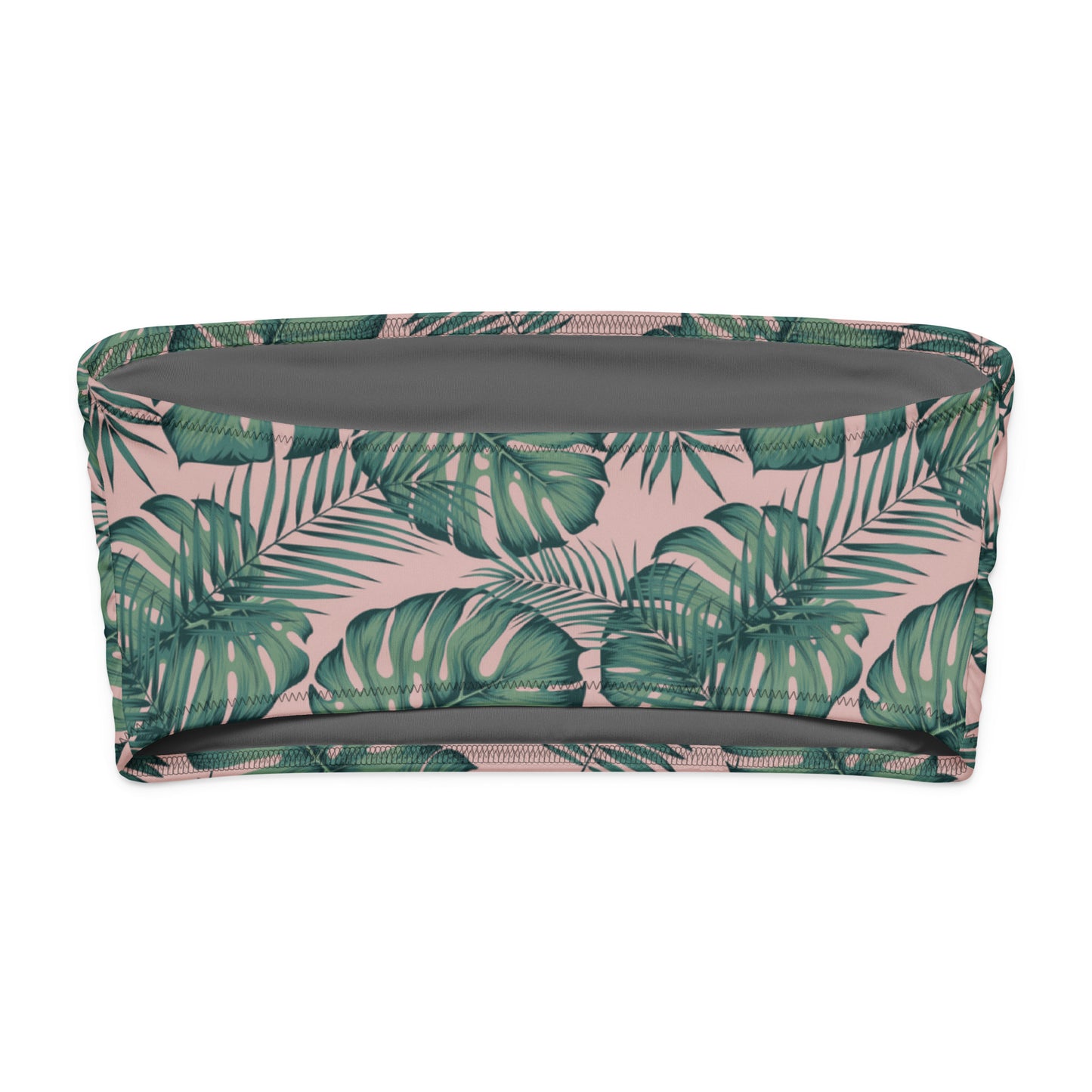Back of bandeau bikini top with design of green palm leaves set on a pink background.
