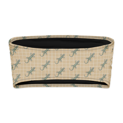 Beige bikini top with pattern of green geckos.