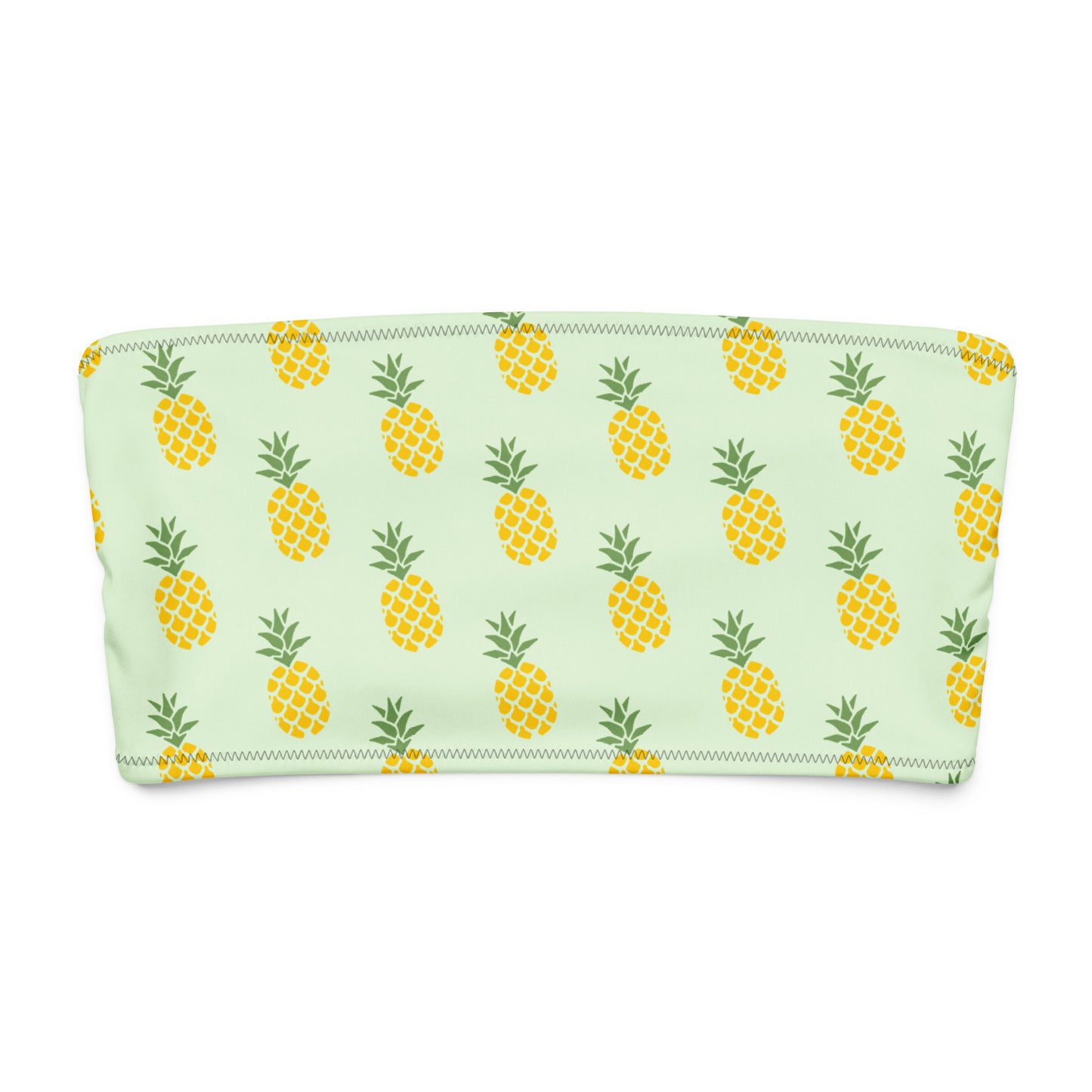 Bandeau bikini top with all-over pineapple design, set on a light-green background.
