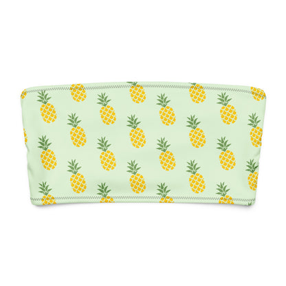 Bandeau bikini top with all-over pineapple design, set on a light-green background.