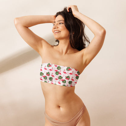 Woman wearing white bandeau bikini top with all-over flamingos design.