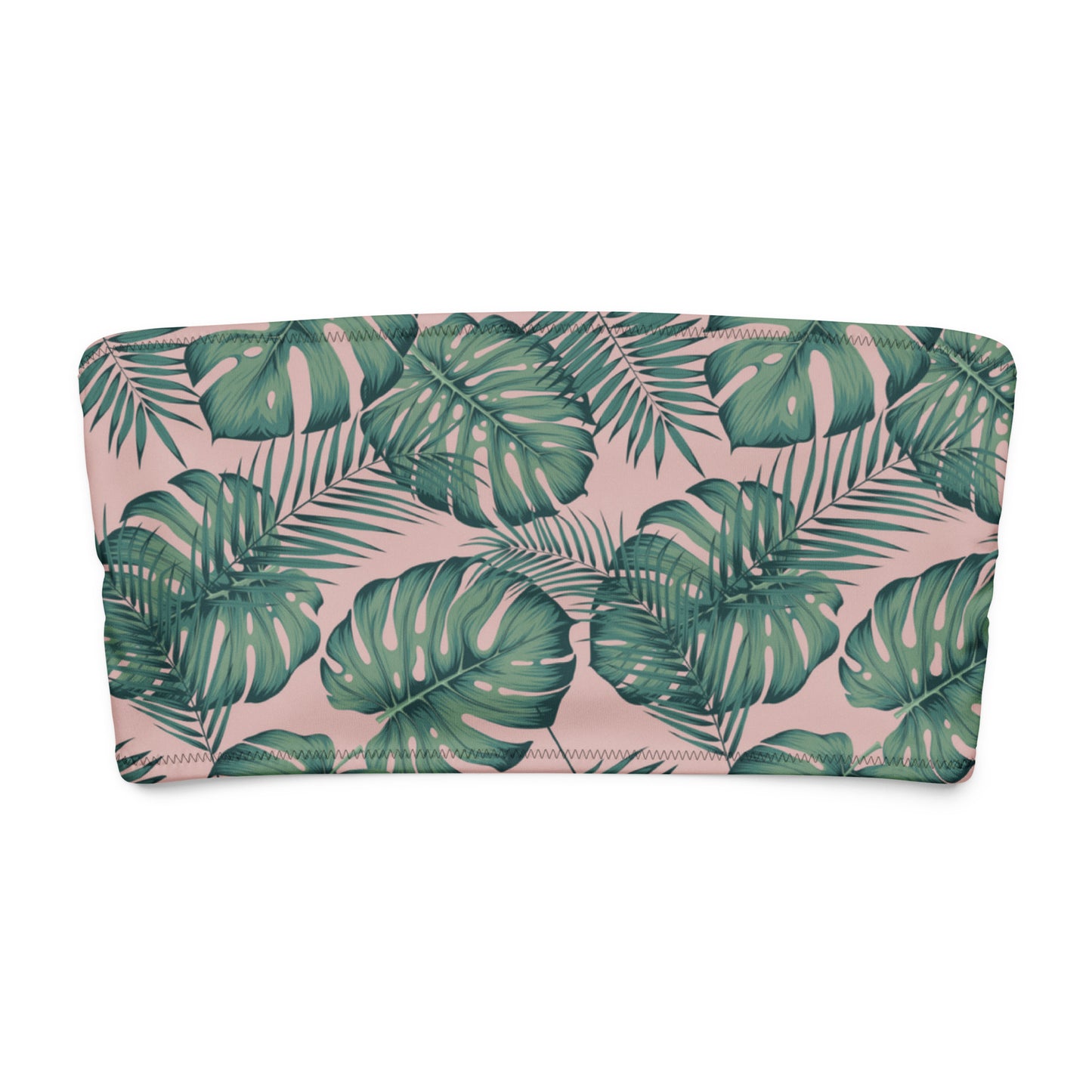 Bandeau bikini top with design of green palm leaves set on a pink background.