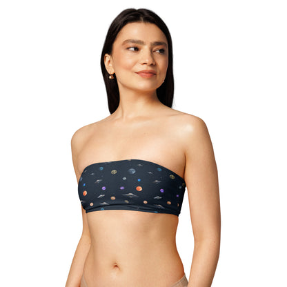 Woman wearing bikini top with pattern of UFOs and planets in space.