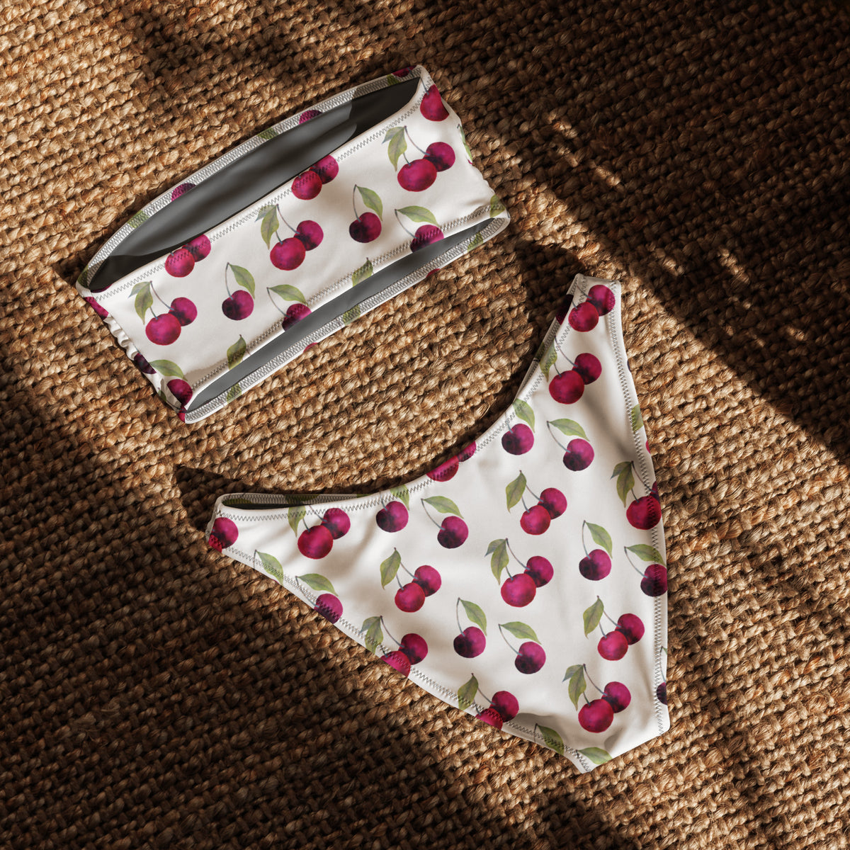 Back of white bandeau bikini with all-over design cherries. Interior is gray.