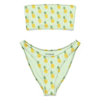 Bandeau bikini with an all-over pineapple design set on a light-green background.