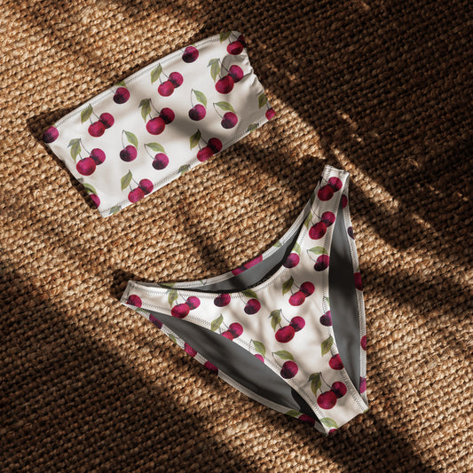 White bandeau bikini with all-over design cherries. Interior is gray.