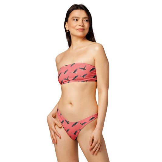 Woman wearing red bikini with pattern of bald eagles.