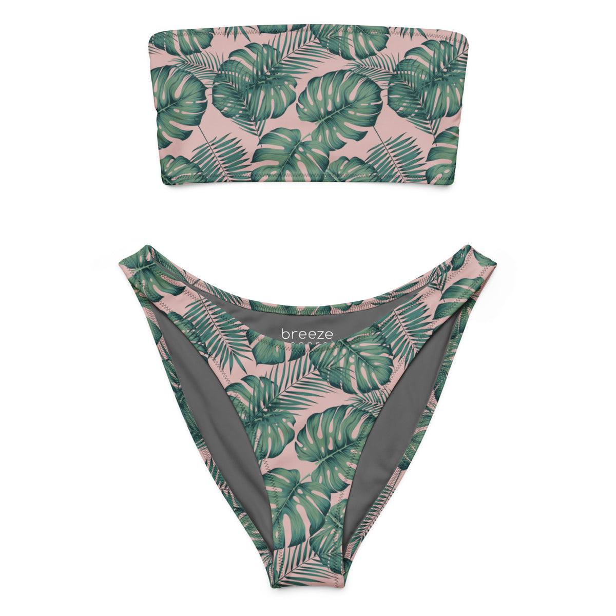 Bandeau bikini with design of green palm leaves set on a pink background.