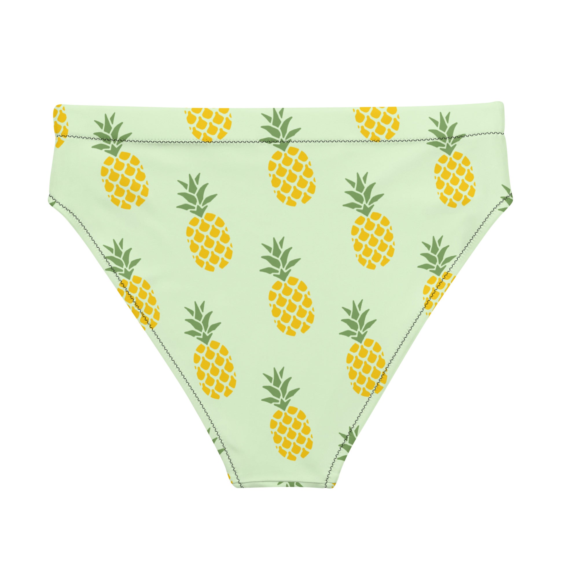 Back of bikini bottom with pineapple pattern set on a light-green background.