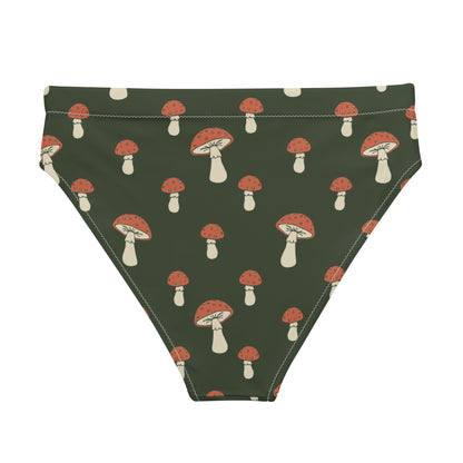 Back of bikini bottom with pattern of mushrooms set on a green background.