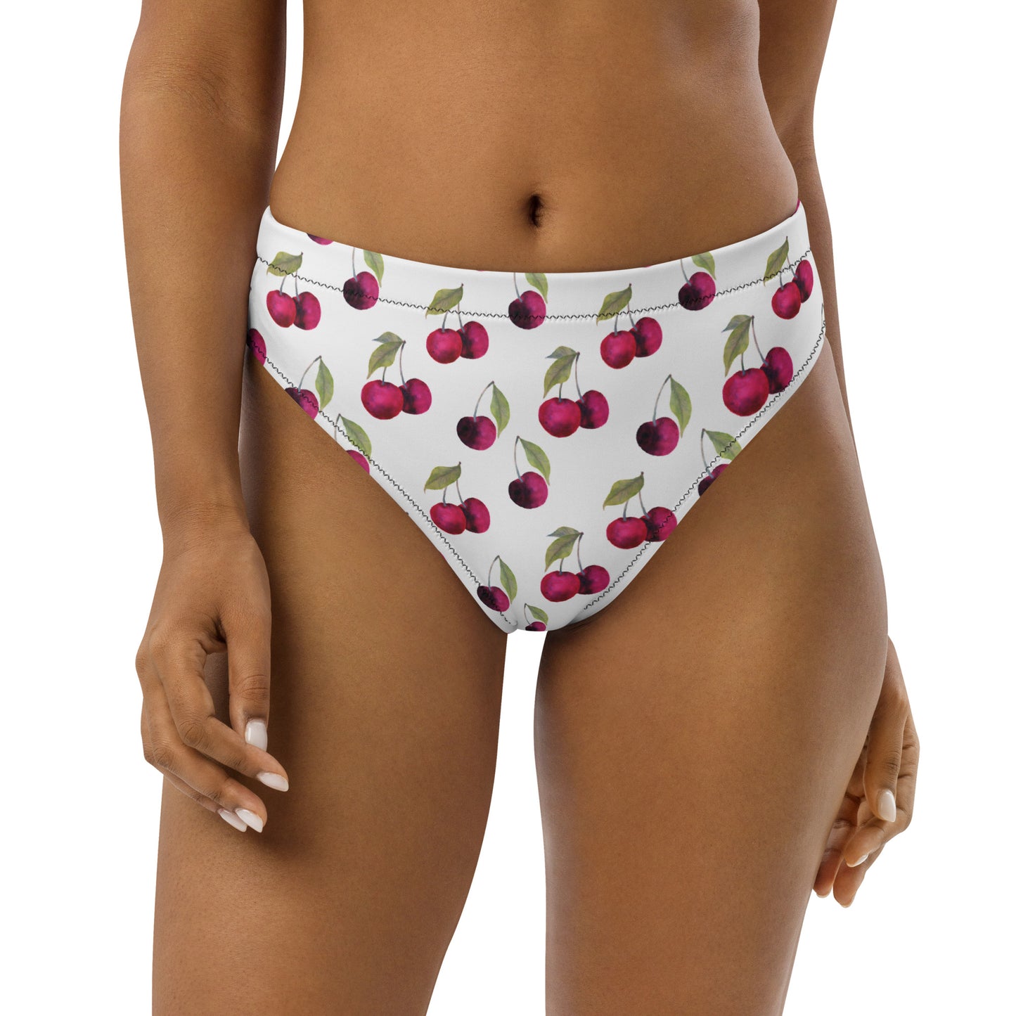 Woman wearing bikini bottom with all-over cherry pattern set on white background.