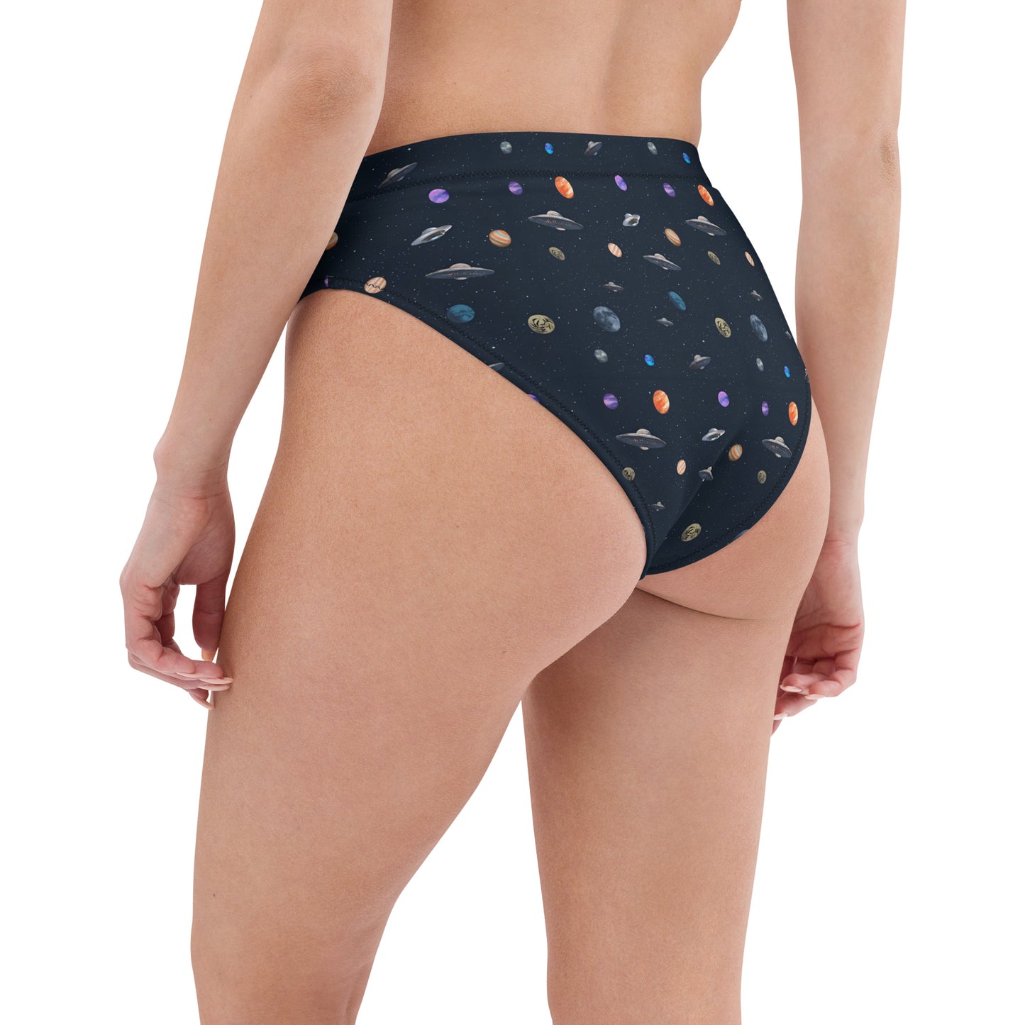 Woman wearing bikini bottom with pattern of UFOs and planets in space.