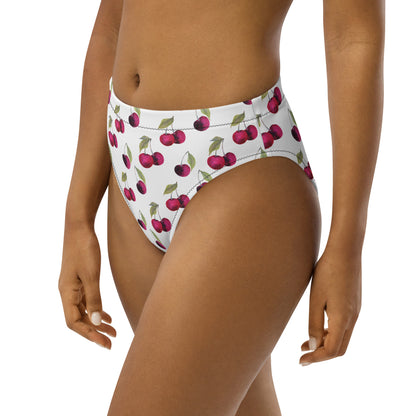 Woman wearing bikini bottom with all-over cherry pattern set on white background.