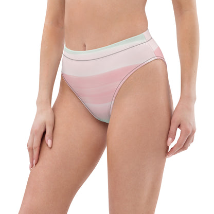 Woman wearing bikini bottom with design resembling watercolor. Dominant colors are pink and light green.
