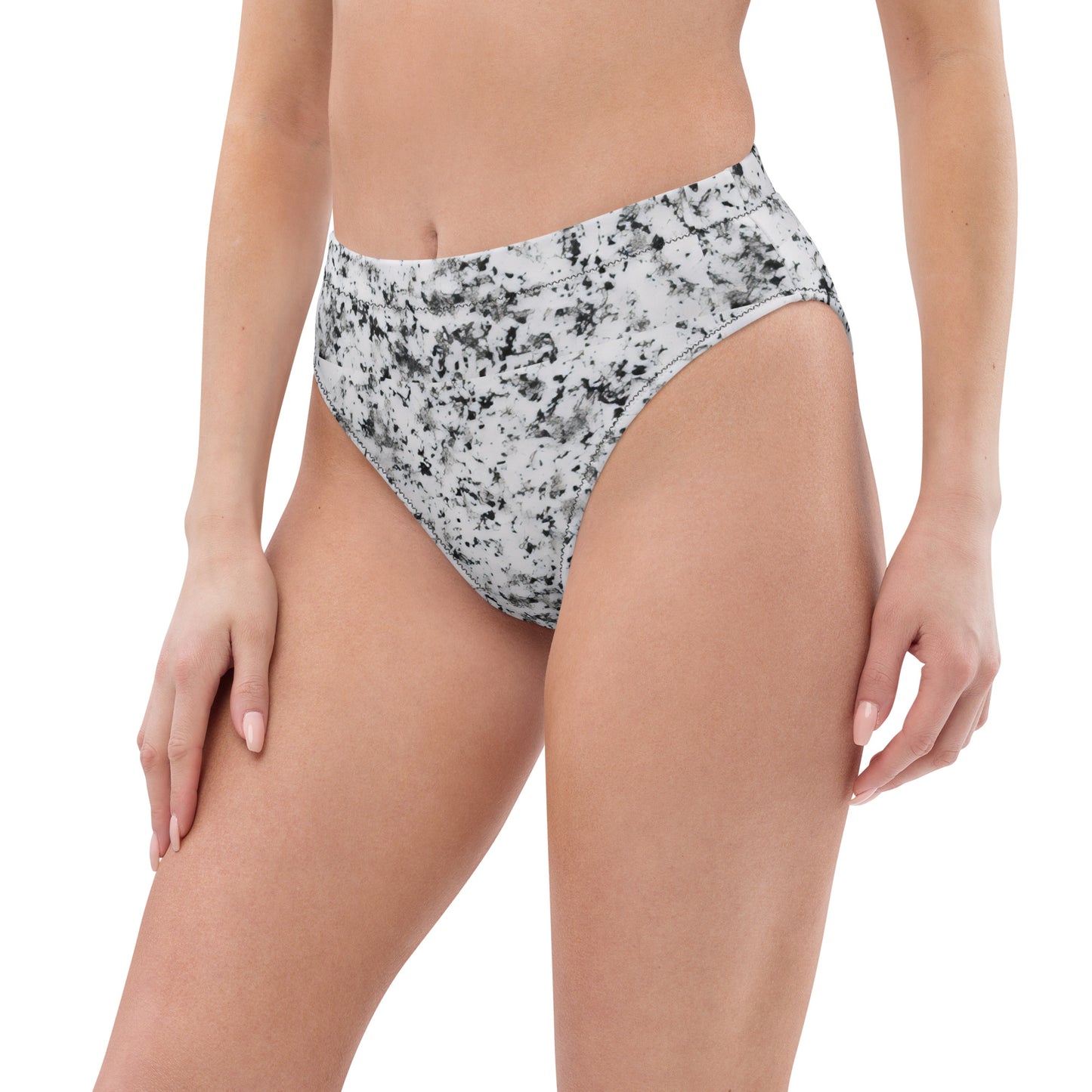 Woman wearing bikini bottom with pattern of black splotches set on a white background.