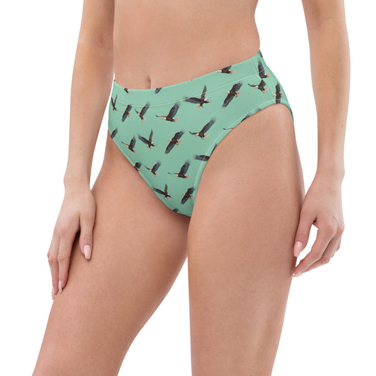 Woman wearing green bikini bottom with pattern of bald eagles.