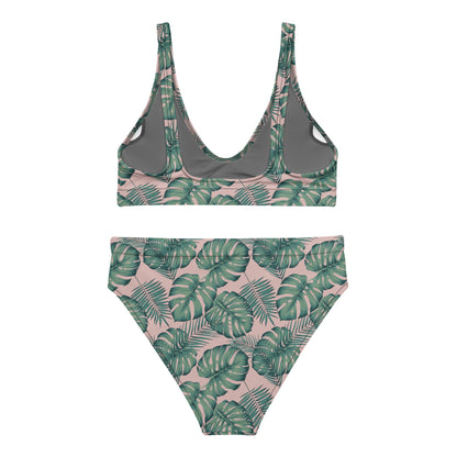 Back of bikini with pattern of green palm leaves set on a pink background.